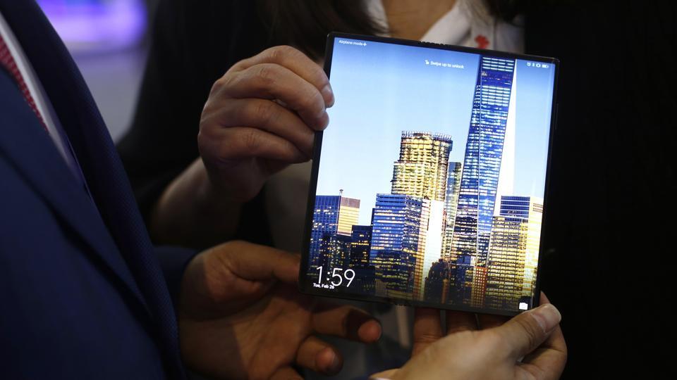 FILE - In this Tuesday, Feb. 26, 2019 file photo, a man holds the new Huawei Mate X foldable 5G smartphone during the Mobile World Congress wireless show, in Barcelona, Spain.
