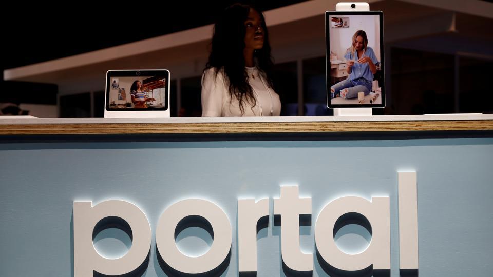 FILE PHOTO: A worker stands behind a Portal booth during Facebook Inc